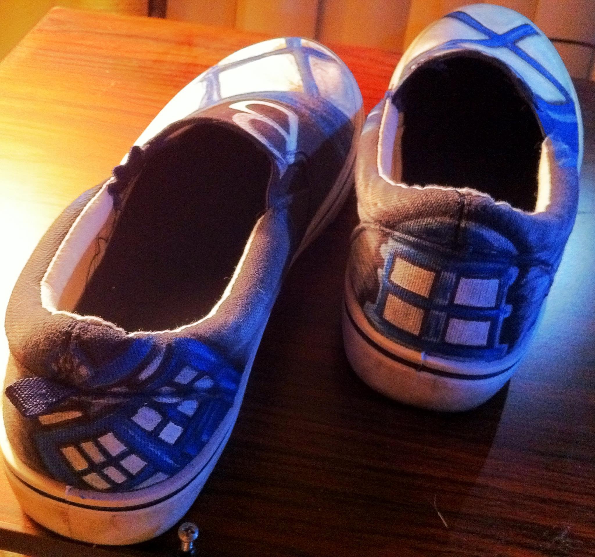 Blue white sneakers on wooden table